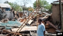 Alabachew Belay stands among the remains of his destroyed property in Ataye, Ethiopia, on May 15, 2021. - More than 100 civilians died in a recent flare-up of violence in the town of Ataye that also saw the assailants torch more than 1,500 buildings.