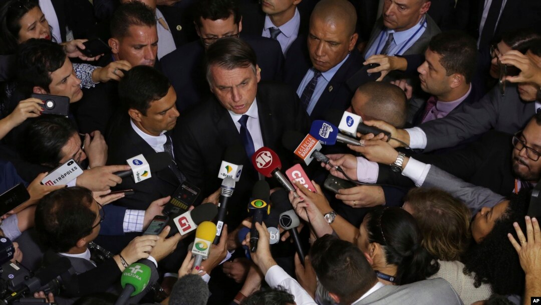 Brazil's President Jair Bolsonaro speaks to the press after signing a second decree that eases gun restrictions, at the Planalto presidential palace in Brasilia, Brazil, May 7, 2019. 