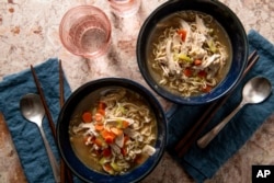This image shows a recipe for chicken ramen noodle soup. (Cheyenne M. Cohen/Katie Workman via AP)