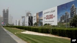 In this Wednesday, June 6, 2018 photo, billboards advertise luxury villas and apartments in Dubai, United Arab Emirates. A new report released Tuesday, June 12, 2018, by the Washington-based Center for Advanced Defense Studies, relying on leaked property data from the city-state, described Dubai’s real-estate market as a haven for money launderers, terror financiers and drug traffickers sanctioned by the U.S. in recent years. Officials in Dubai said they could not comment on the report. (AP Photo/Kamran Jebreili) 