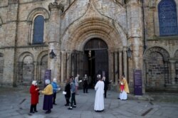 Dean of Durham Andrew Tremlett greets members of the congregation following the Easter Sunday Eucharist service at Durham Cathedral in Durham, Britain, Apr. 4, 2021.