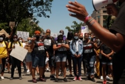 Demonstrators protest near the White House in Washington, June 7, 2020, over the death of George Floyd, an African American man who died after being restrained by Minneapolis police officers.