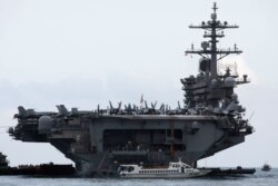 FILE - The USS Theodore Roosevelt is seen while entering into the port in Da Nang, Vietnam, March 5, 2020.