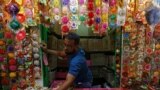 A man arranges "Rakhis" or sacred threads as he waits for customers at his roadside stall ahead of the Hindu festival Raksha Bandhan celebrations, in Kolkata, India.