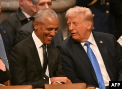 Former U.S. President Barack Obama speaks with President-elect Donald Trump before the funeral service for former U.S. President Jimmy Carter at the Washington National Cathedral in Washington on Jan. 9, 2025.