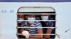 Migrant workers, who were stranded in the western state of Rajasthan due to a coronavirus lockdown, look out from the window of a train upon their arrival in their home state of eastern West Bengal, India.