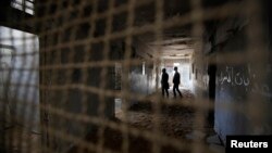 Palestinians visit prison cells in Gaza City that had been used by Israeli security services to keep Palestinian prisoners during Israel's occupation of Gaza Strip, April 11, 2013. 