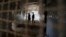 Palestinians visit prison cells in Gaza City that had been used by Israeli security services to keep Palestinian prisoners during Israel's occupation of Gaza Strip, April 11, 2013. 