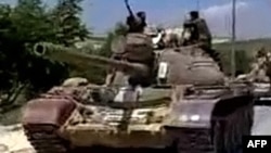 Military tanks drive into the Jabal Al-Zawya area of Idlib on August 1, 2011 in this still image taken from video posted on a social media website. The death toll in Syria's violent crackdown on opposition to President Bashar al-Assad in the city of Hama 