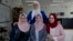 Tamara Awaysa, 17, left, Wassan al-Sayyed,17, center and Massa Halawa,16, right, pose for a photo with their mentor Yamama Shakaa in the West Bank city of Nablus. For the 11th graders from the Israeli-occupied West Bank, the ticket of admission to the World Pitch Summit signals a particularly dramatic leap because of the limited opportunities at home.