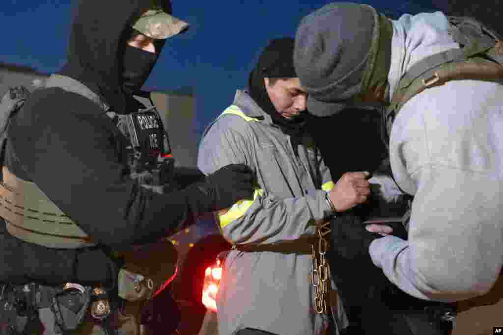 U.S. Immigration and Customs Enforcement officers detain a person, Jan. 27, 2025, in Silver Spring, Maryland.