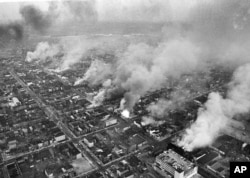 FILE - In this April 5, 1968 file photo, buildings burn in the northeast section of Washington, set afire during a day of demonstrations and rioting in reaction to the assassination of Dr. Martin Luther King Jr.