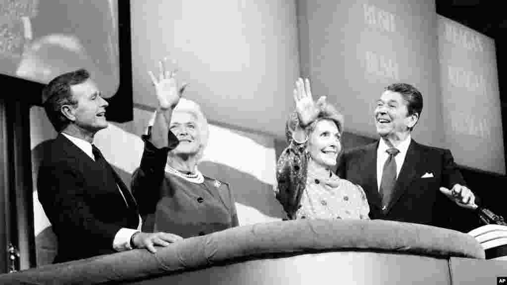FILE - President Ronald Reagan, far right, first lady Nancy Reagan, right, Vice President George Bush and his wife, Barbara, react to cheers from the floor at the final session of the Republican National Convention in Dallas, Texas, Aug. 23, 1984. Reagan and Bush were renominated.