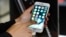 FILE - A customer tries out Apple's iPhone 7 in Seoul, South Korea, Oct. 21, 2016.