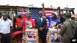 FILE - Comedians stage a mock election in the village of Kogelo, the home town of Sarah Obama, step-grandmother of President Barack Obama, in western Kenya, Tuesday, Nov. 8, 2016.