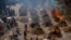 Multiple funeral pyres of victims of COVID-19 burn at a ground that has been converted into a crematorium for mass cremation in New Delhi, India, April 24, 2021.