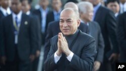 Cambodia's King Norodom Sihamoni, center, greets his government officials upon his arrival for the water festival in front of Royal Palace in Phnom Penh, Cambodia, Sunday, Nov. 13, 2016. 