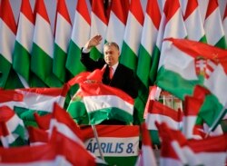 FILE - Prime Minister Viktor Orban waves during the final electoral rally of his Fidesz party in Szekesfehervar, Hungary.
