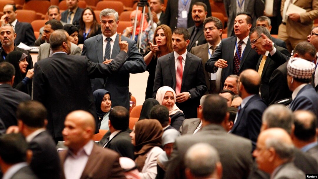 Members of the newly elected Iraqi parliament point fingers at each other after an argument broke out at the parliament headquarters in Baghdad July 1, 2014.