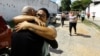 In Tocuyito, Venezuela, people embrace loved ones who were arrested and imprisoned during protests in the wake of the nation's disputed presidential election, Nov. 16, 2024. More than 100 detained during the protests were freed Saturday, according to rights group Foro Penal.