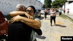 In Tocuyito, Venezuela, people embrace loved ones who were arrested and imprisoned during protests in the wake of the nation's disputed presidential election, Nov. 16, 2024. More than 100 detained during the protests were freed Saturday, according to rights group Foro Penal.