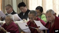 Tibetan parliamentarians read a printed message by the Dalai Lama during the eleventh session of the Tibetan parliament-in-exile in Dharmsala, India, Monday, March 14, 2011. The Tibetan spiritual leader Dalai Lama Thursday said that he will give up his po