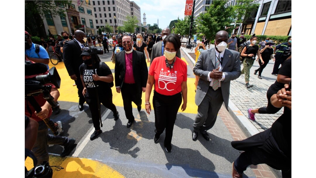 District of Columbia Mayor Muriel Bowser walks on the street leading to the White House after the words Black Lives Matter were painted in enormous bright yellow letters on the street by city workers and activists, June 5, 2020, in Washington.