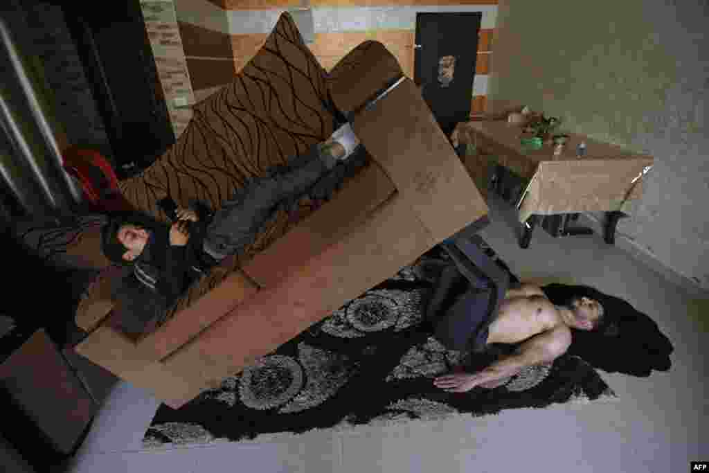 Palestinian fitness trainer and bodybuilder Ahmed Sawi trains at his home in Gaza City.