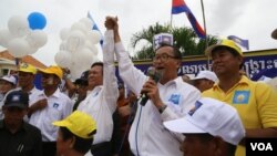 Kem Sokha, left, and Sam Rainsy at a campaign rally in Kampong Cham province. 