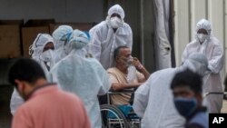 26일 인도 뭄바이에 설치된 대규모 임시 병원에서 의료진이 신종 코로나바이러스 감염 환자를 이동시키고 있다.