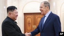 In this photo released by Russian Foreign Ministry Press Service via their telegram channel, Korean leader Kim Jong Un, left, and Russian Foreign Minister Sergey Lavrov greet each other during a meeting in Pyongyang, North Korea, on Oct. 19, 2023.