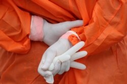 A health worker holds a glove outside the San Jose public hospital emergencies entrance, amid the spread of the coronavirus disease (COVID-19) in Santiago, Chile, May 28, 2020.