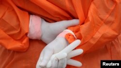 A health worker holds a glove outside the San Jose public hospital emergencies entrance, amid the spread of the coronavirus disease (COVID-19) in Santiago, Chile, May 28, 2020. 