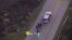 In this image made from a Friday, Sept. 16, 2016 police video, Terence Crutcher, top, is pursued by police officers as he walk to an SUV in Tulsa, Okla.