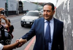 Samuel "Sammy" Morales, brother and political adviser of Guatemalan President Jimmy Morales, shakes hands with a person after being acquitted by a Guatemalan court on corruption charges, in Guatemala City, Guatemala, Aug. 19, 2019.