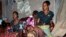 Family and friends comfort Irene Mboyo Mola, 30, whose husband died in May from Ebola and whose six children have been vaccinated but she refused, saying she doesn't believe he died from the disease, in her house in the town of Mbandaka, Congo, June 1, 2018.