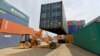 FILE - A mobile crane carries a container at Thar Dry Port in Sanand in the western state of Gujarat, India, Feb. 13, 2017. 