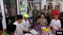 Wakil Gubernur Jawa Timur Saifullah Yusuf (kedua dari kiri) saat berdialog dengan keluarga calon jamaah haji asal Pasuruan yang tertahan di Filipina, Kamis 25 Agustus 2016 (Foto: VOA/Petrus Riski).