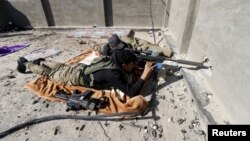 Iraqi security forces sniper looks through rifle scope while guarding position in the city of Ramadi, Jan. 16, 2016.