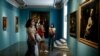 Visitors admires paintings part of the exhibition The Time of Caravaggio, Masterpieces of the Roberto Longhi collection, on display at the Capitoline Museums in Rome, June 16, 2020.