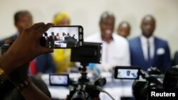 Journalists use their mobile phones and cameras at a candidate's pre-election news conference in Kinshasa, Democratic Republic of Congo, Dec. 25, 2018.