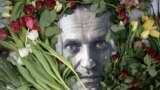 (FILES) Flowers are seen placed around a portrait of late Russian opposition leader Alexei Navalny at a makeshift memorial in front of the former Russian consulate in Frankfurt am Main, western Germany, on February 19, 2024, three days after Navalny died 