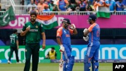 (L-R) Pakistan's Haris Rauf looks on as India's Rishabh Pant talks with teammate Suryakumar Yadav after Pant hit four during the ICC men's Twenty20 World Cup 2024 group A cricket match between India and Pakistan at Nassau County International Cricket Stad