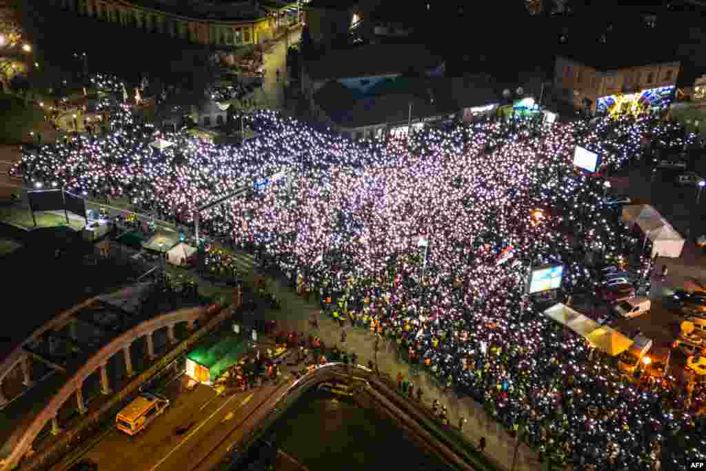 People demonstrate on a main boulevard in the central Serbian city of Kragujevac, Feb, 15, 2025, amid months long calls for government accountability and reforms.&nbsp;The demonstration is the latest in a series of mass protests to rock the Balkan country after the collapse of a roof at a train station killed 15 people in the northern Serbian city of Novi Sad.