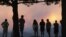 People watch a giant smoke plume rising from the Waldo Canyon Fire during sunset, west of Colorado Springs