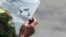 A man smokes a cigar as he reads a local newspaper in Havana, Cuba, Sept. 13, 2016.