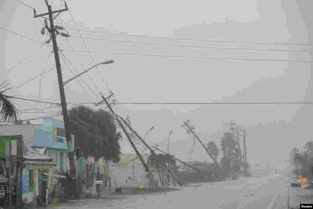 Utility poles are seen downed by strong wind gusts as Hurricane Milton approaches Fort Myers, Florida, Oct. 9, 2024.&nbsp;