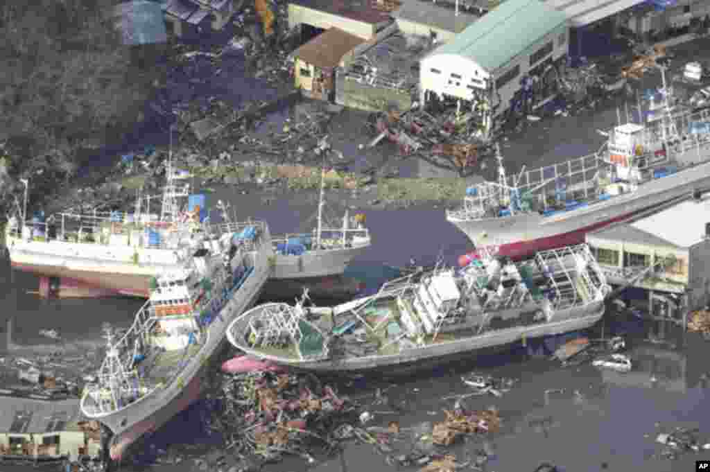 Damaged ships are seen after a tsunami and earthquake in Kesennuma City in Miyagi Prefecture March 12, 2011. Japan confronted devastation along its northeastern coast on Saturday, with fires raging and parts of some cities under water after a massive eart