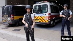 Armed policemen stand guard at the entrance as a prison car carrying former British banker Rurik Jutting enters High Court to launch his appeal, in Hong Kong, Dec. 12, 2017.