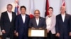 From left, prime ministers Scott Morrison of Australia, Shinzo Abe of Japan, Peter O'Neill of Papua New Guinea, Jacinda Ardern of New Zealand and U.S. Vice President Mike Pence pose after signing the Papua New Guinea Electrification Partnership, Nov. 18, 2018, in New Guinea.